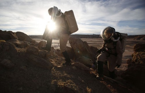 Melissa Battler, left, a geologist and commander and Csilla Orgel, a geologist on Crew 125 EuroMoonMars B mission, climb a rock formation to collect geologic samples to be studied at the Mars Desert Research Station (MDRS) outside Hanksville in the Utah d