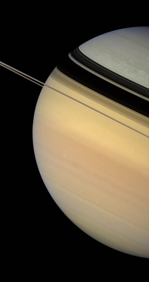 This image, taken on the same day, captures Saturn's color contrast. It is unknown why Saturn is color-patterned as it is.